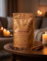 Load image into Gallery viewer, Golden Desire tea package in a warm, candlelit cacao-gold living room scene