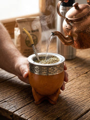 Hot water being poured into the engraved imperial mate gourd