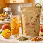 Load image into Gallery viewer, Iced Golden Tropic tea beside the package in a bright citrus-toned kitchen